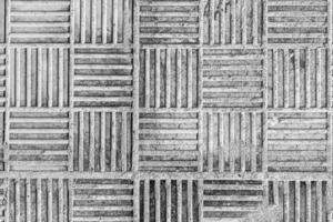 Top view on paving stone road. Old pavement of concrete texture. Cobblestone sidewalk. Black and white abstract background for design. photo