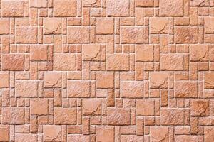 Texture of a wall covered with decorative brick-like tiles. Abstract background for design. photo