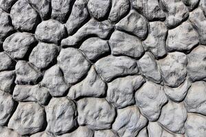Black and white texture of a wall made of stones. Abstract background. photo