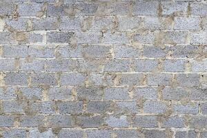 Monochrome texture of a wall made of concrete blocks connected cement. Abstract background. photo