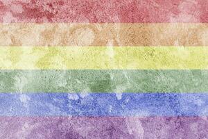 Rainbow LGBTQ or gay pride flag on decorative plaster or concrete texture. Abstract background. photo