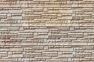 Texture of a wall covered with decorative brick-like tiles. Abstract background for design. photo