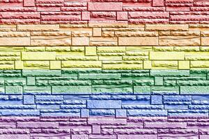 Rainbow LGBTQ or gay pride flag on decorative tiles texture. Abstract background photo
