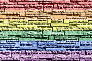 Rainbow LGBTQ or gay pride flag on decorative tiles texture. Abstract background photo