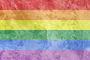 Rainbow LGBTQ or gay pride flag on decorative plaster or concrete texture. Abstract background. photo