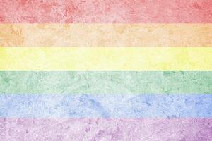 Rainbow LGBTQ or gay pride flag on decorative plaster or concrete texture. Abstract background. photo