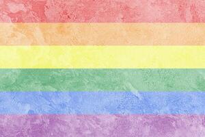 Rainbow LGBTQ or gay pride flag on decorative plaster or concrete texture. Abstract background. photo