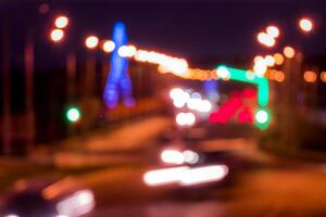 Traces of headlights from cars moving at night on the bridge, illuminated by lanterns. Abstract blured defocused city landscape with highway. photo