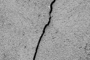 Black and white texture of cracked concrete wall or cement. photo