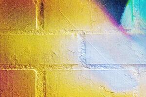 A fragment of colorful graffiti painted on a wall. Abstract urban background. photo