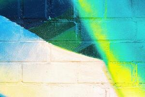 A fragment of colorful graffiti painted on a wall. Abstract urban background. photo