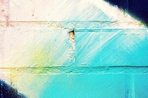 A fragment of colorful graffiti painted on a wall. Abstract urban background. photo