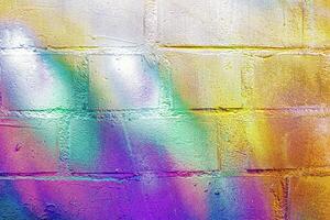 A fragment of colorful graffiti painted on a wall. Abstract urban background. photo