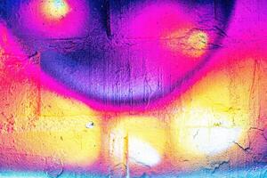 A fragment of colorful graffiti painted on a wall. Abstract urban background. photo