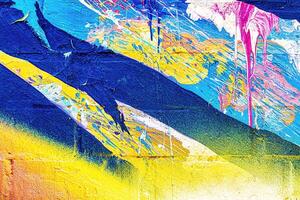 A fragment of colorful graffiti painted on a wall. Abstract urban background. photo