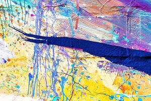 A fragment of colorful graffiti painted on a wall. Abstract urban background. photo