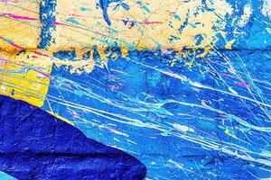 A fragment of colorful graffiti painted on a wall. Abstract urban background. photo