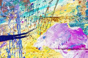 A fragment of colorful graffiti painted on a wall. Abstract urban background. photo