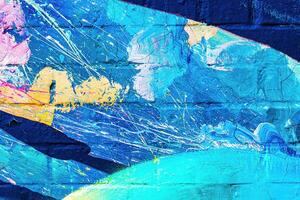 A fragment of colorful graffiti painted on a wall. Abstract urban background. photo