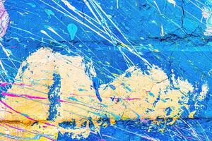 A fragment of colorful graffiti painted on a wall. Abstract urban background. photo