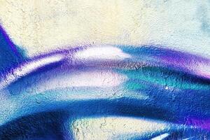 A fragment of colorful graffiti painted on a wall. Abstract urban background. photo