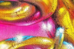 A fragment of colorful graffiti painted on a wall. Abstract urban background. photo