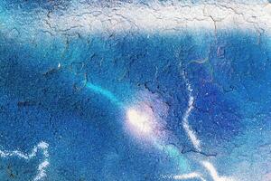 A fragment of colorful graffiti painted on a wall. Abstract urban background. photo