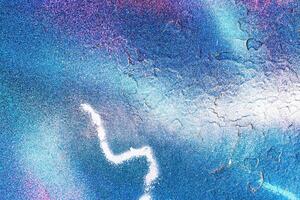 A fragment of colorful graffiti painted on a wall. Abstract urban background. photo