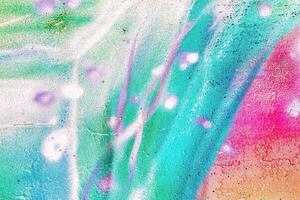 A fragment of colorful graffiti painted on a wall. Abstract urban background. photo