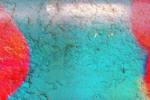 A fragment of colorful graffiti painted on a wall. Abstract urban background. photo