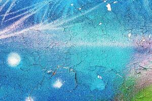 A fragment of colorful graffiti painted on a wall. Abstract urban background. photo