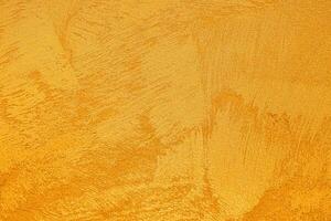 Texture of golden decorative plaster or concrete. Abstract grunge background. photo