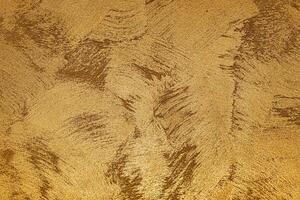 Texture of golden decorative plaster or concrete. Abstract grunge background. photo