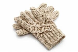 Cozy beige knit gloves with patterns on white background. Warm winter accessory photo