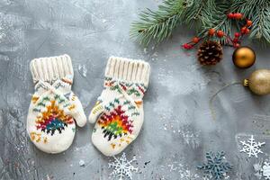Colorful patterned gloves resting on gray concrete table, creating a winter ambiance. Stylish winter accessories photo