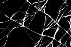 Cracked black glass of a smartphone as an background for design. photo