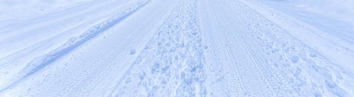 Texture of a snowy road with traces of car tires. photo