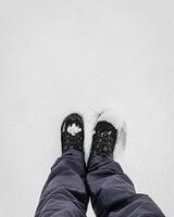 Legs in hiking boots for trekking in the snow. photo