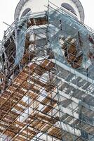 Scaffolding without people on the reconstruction of a historic building. photo