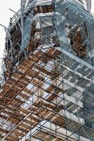 Scaffolding without people on the reconstruction of a historic building. photo
