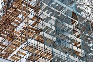 Scaffolding without people on the reconstruction of a historic building. photo