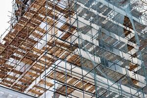 Scaffolding without people on the reconstruction of a historic building. photo