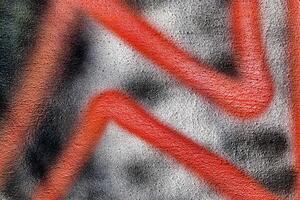 A fragment of colorful graffiti painted on a wall. Abstract urban background. photo