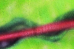 A fragment of colorful graffiti painted on a wall. Abstract urban background. photo