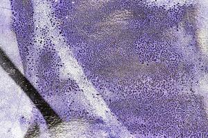 A fragment of colorful graffiti painted on a wall. Abstract urban background. photo