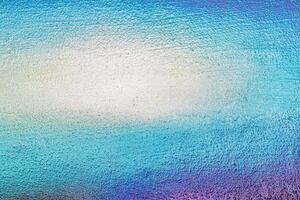 A fragment of colorful graffiti painted on a wall. Abstract urban background. photo