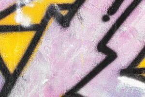 A fragment of colorful graffiti painted on a wall. Abstract urban background. photo