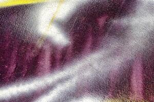A fragment of colorful graffiti painted on a wall. Abstract urban background. photo