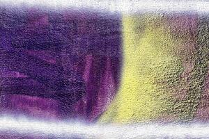A fragment of colorful graffiti painted on a wall. Abstract urban background. photo