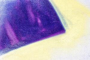 A fragment of colorful graffiti painted on a wall. Abstract urban background. photo